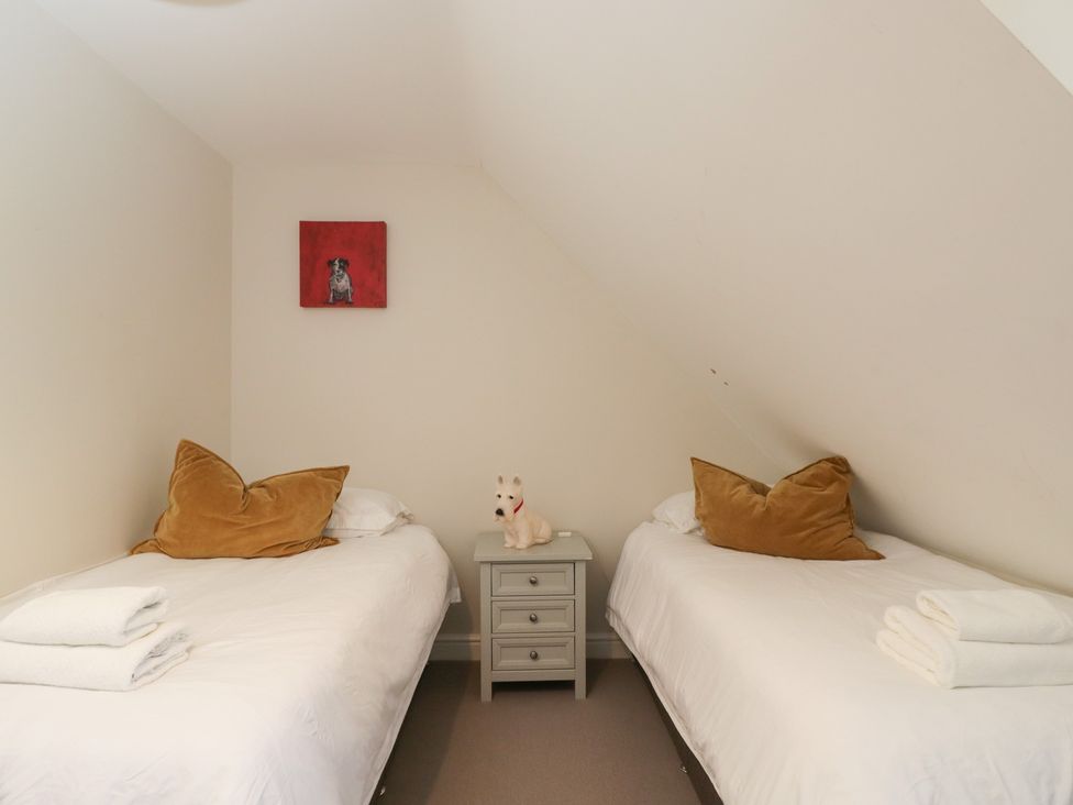 A bedroom with two beds and a nightstand at Flat 6 in 