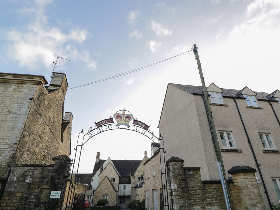 A sign for The Inn with buildings and a road at Flat 6 in 