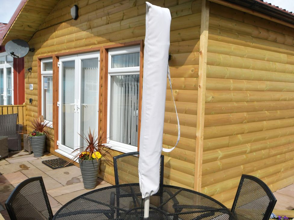 An outdoor seating area with a table, chairs and a covered parasol at 226 Third Avenue in Bridlington