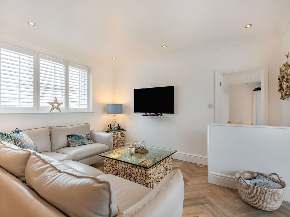 A living room with a sofa and coffee table at 6 Tegafan in Abergele