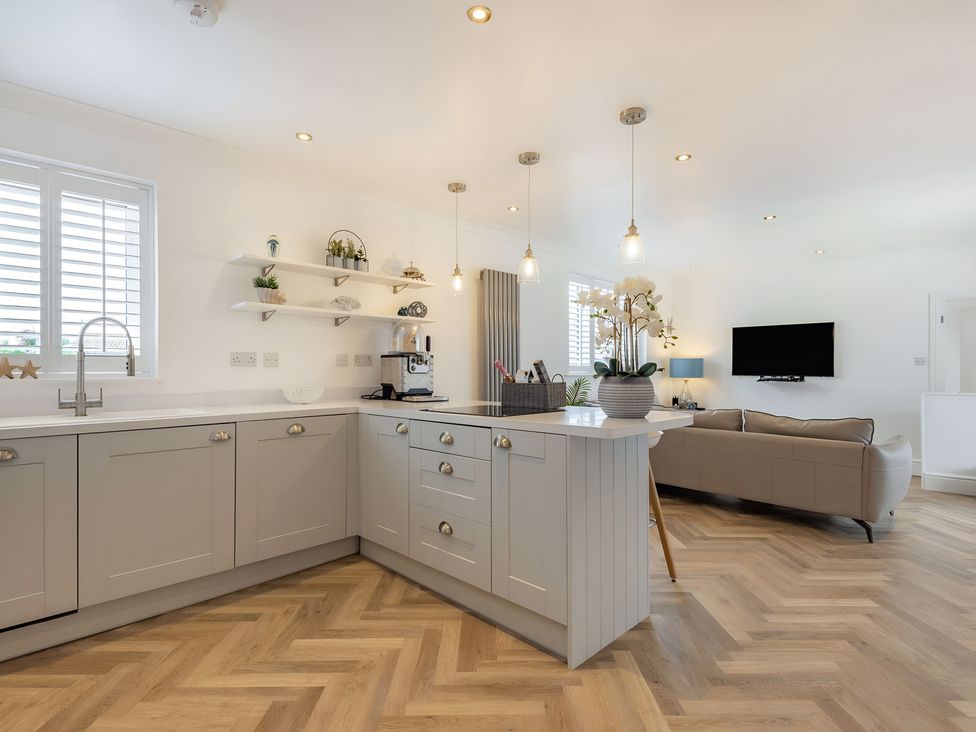 A kitchen with cabinets and countertop at 6 Tegafan in Abergele