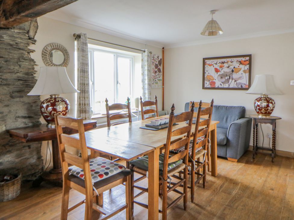 A dining room with a table and chairs at Glanyrafon Smithy in Llandysul