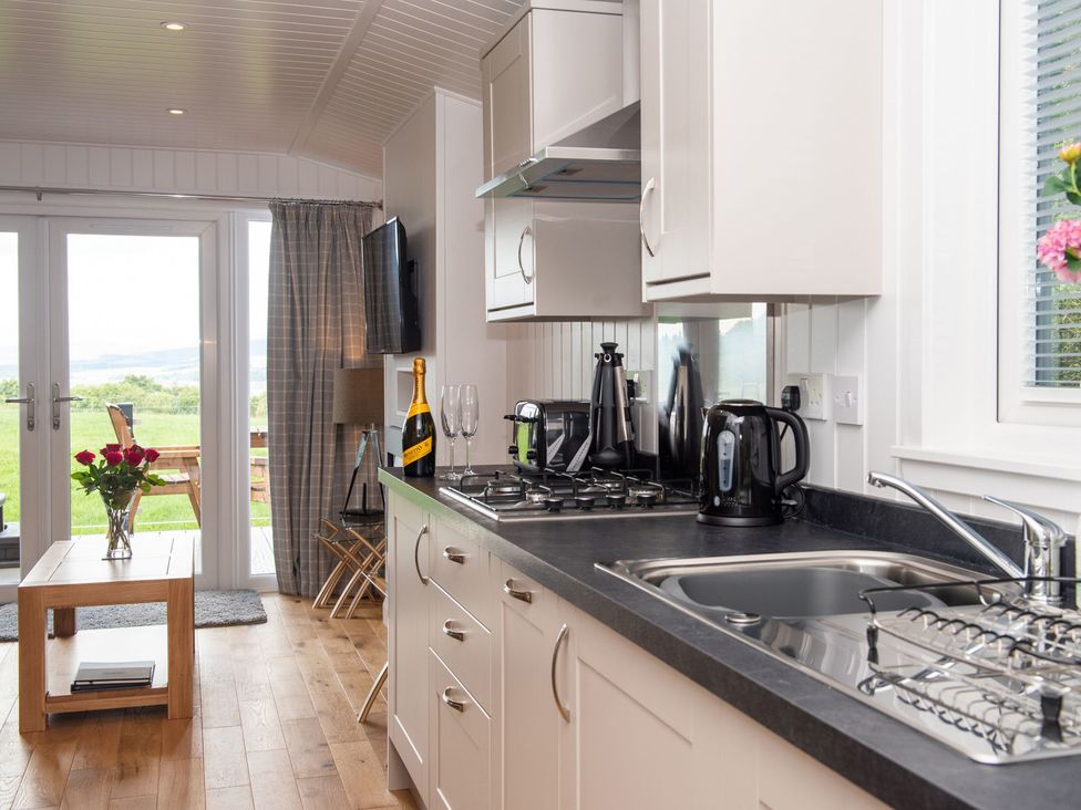 A kitchen with a sink and cooker at Nethermill Lodges in Port Glasgow