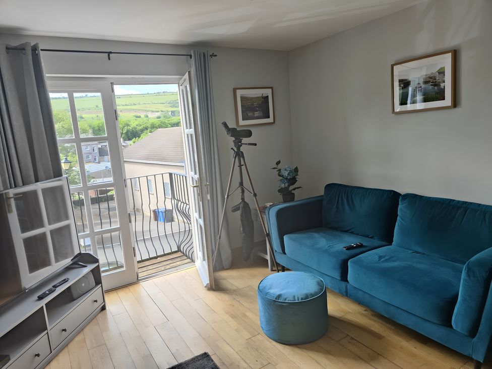 A living room with a sofa and telescope at 17 Castleview in Ballymena