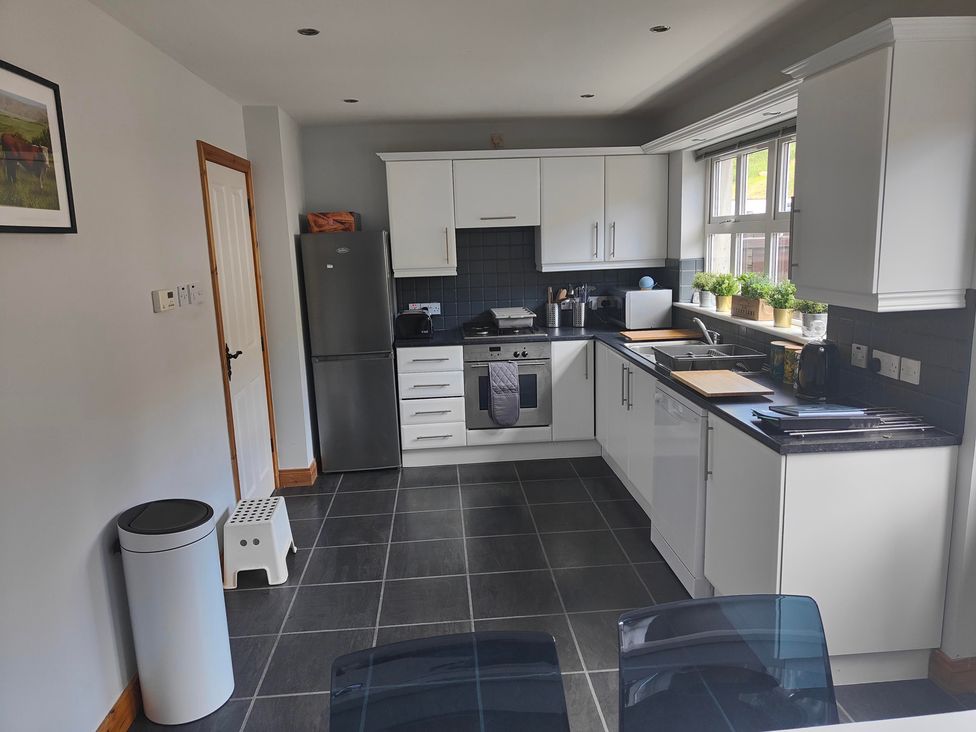 A kitchen with refrigerator, oven and sink at 17 Castleview in Ballymena