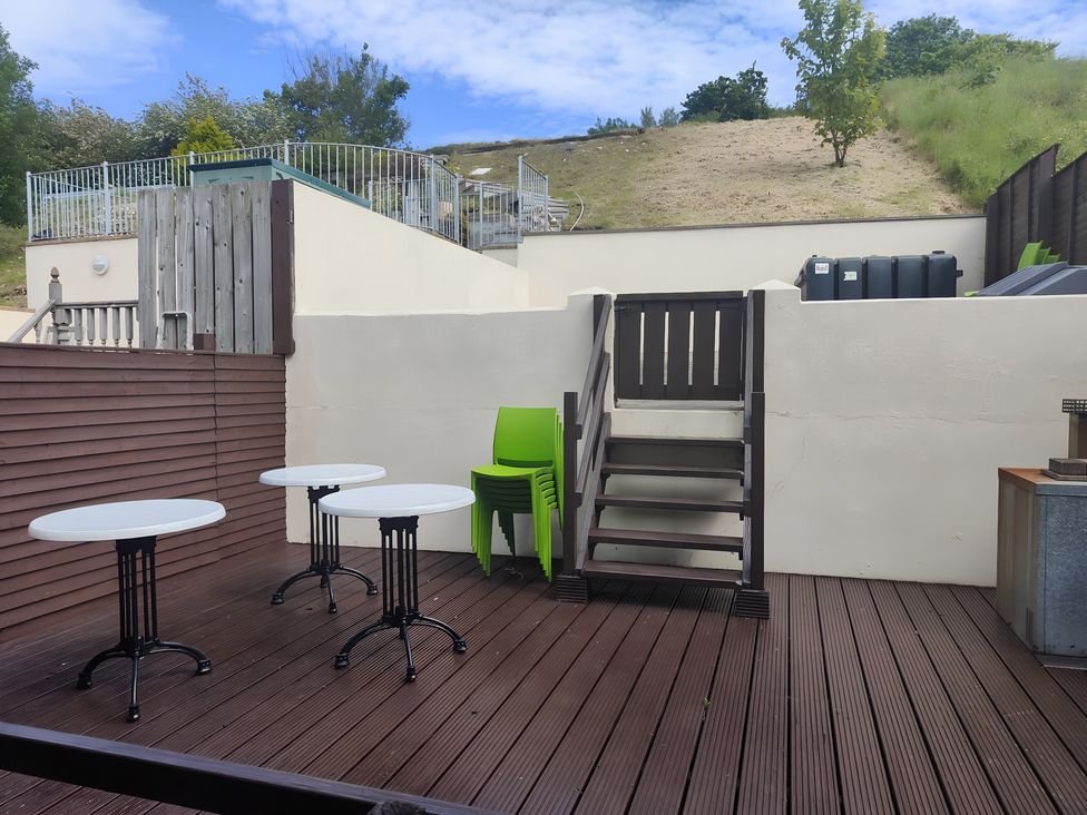 An outdoor area with tables and chairs at 17 Castleview, Ballymena