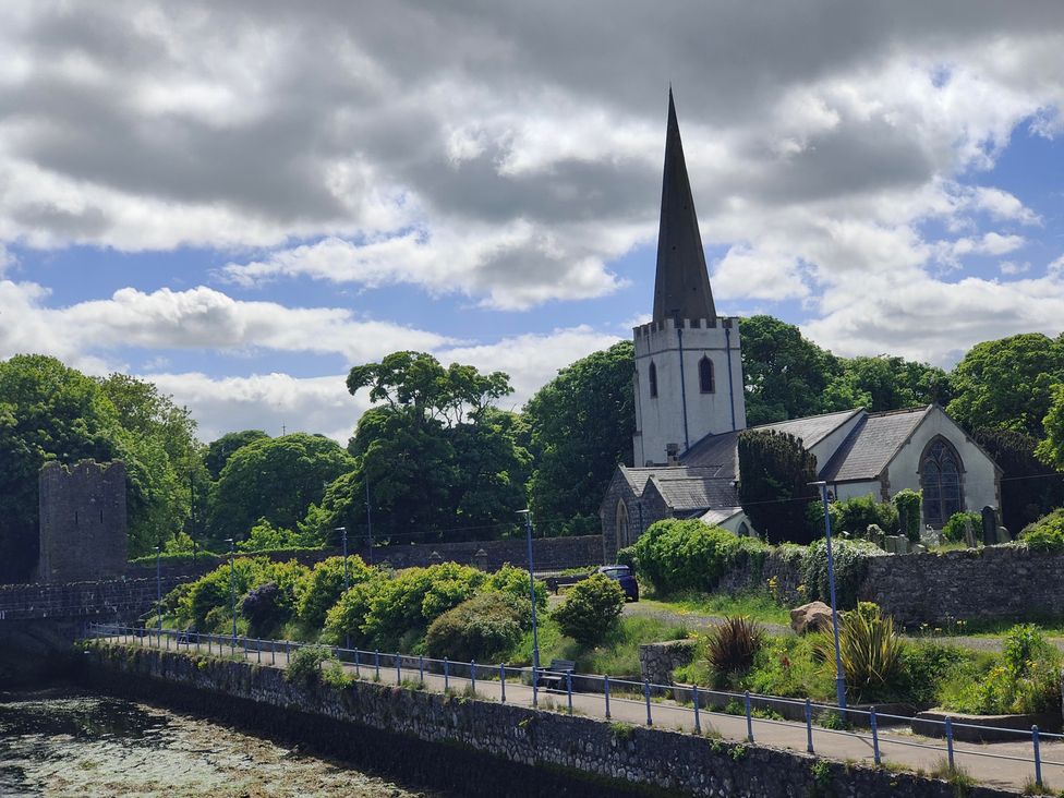 A church near a waterway with greenery at 17 Castleview Ballymena
