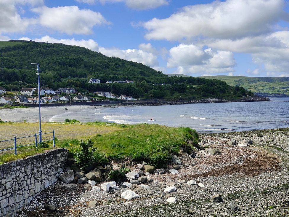A beach view with rocks and houses near the sea at 17 Castleview in Ballymena