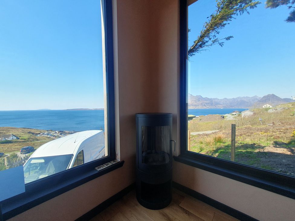 A living room with a view of the sea and mountains at Cullinview Isle of Skye