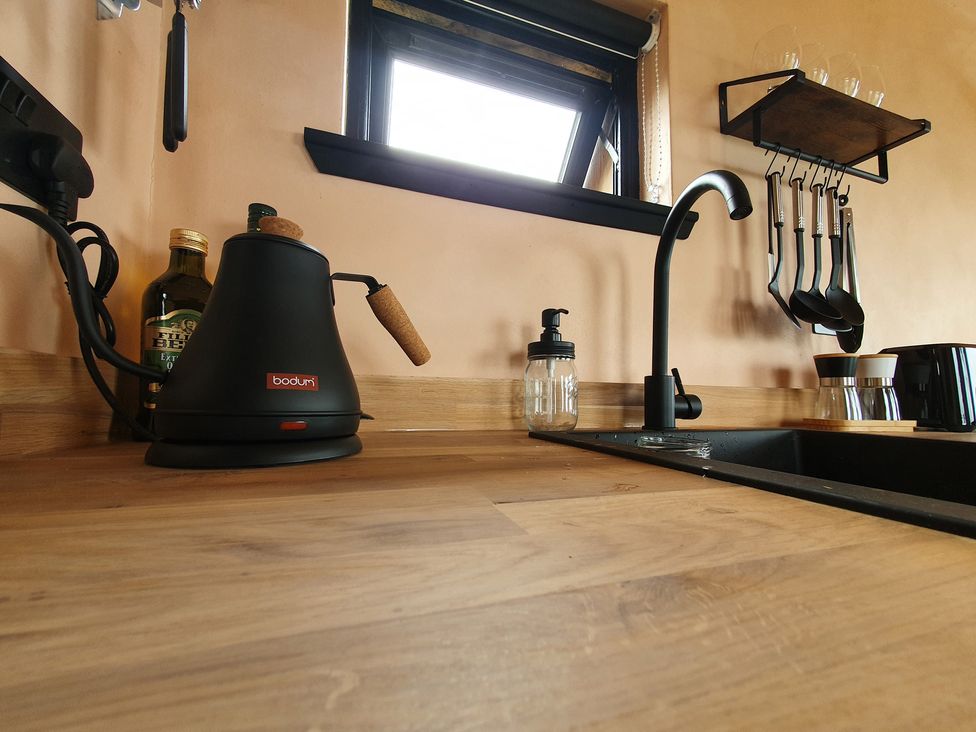 A kitchen with kettle, sink, and various utensils at Cullinview Isle of Skye