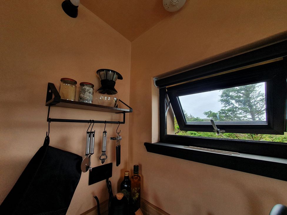 A kitchen with shelves and glass jars at Cullinview Isle of Skye
