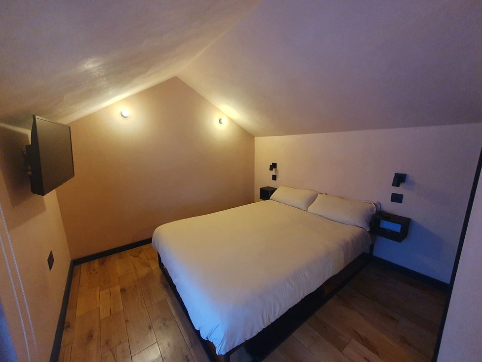 A bedroom with a bed and wall-mounted television at Cullinview in Isle of Skye
