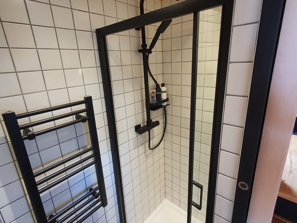 A shower with a towel rack and tiles at Cullinview Isle of Skye