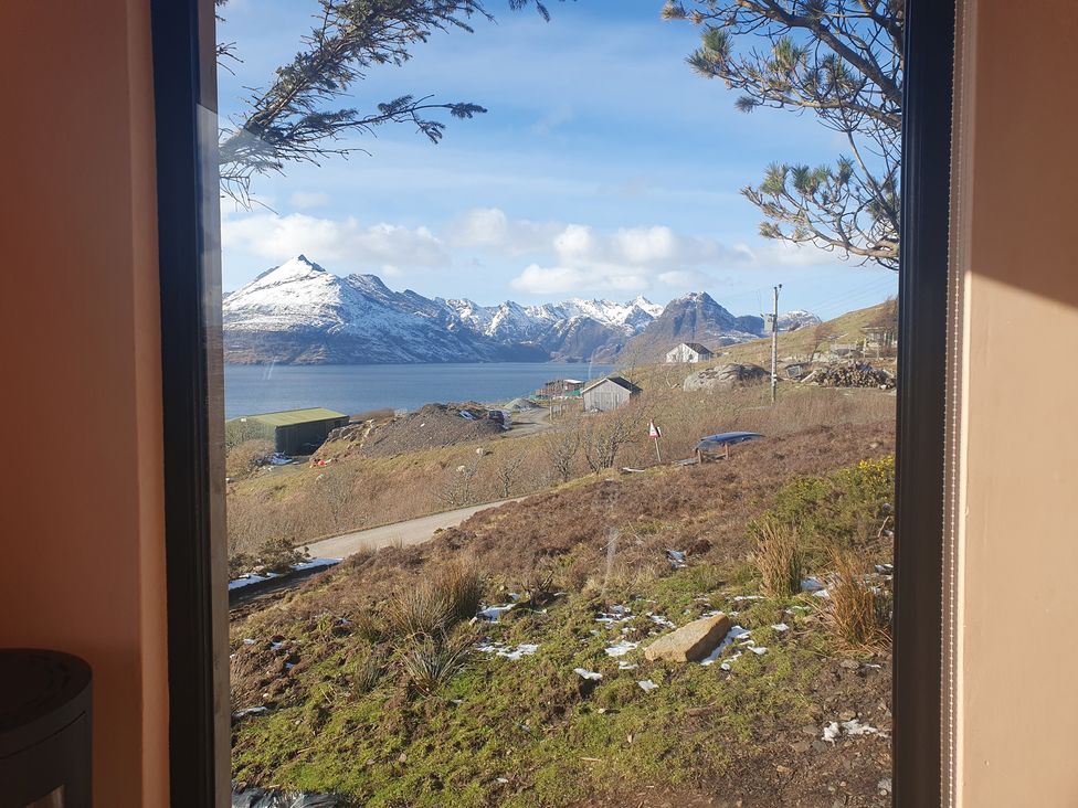 A view of mountains and a lake from indoors at Cullinview Isle of Skye