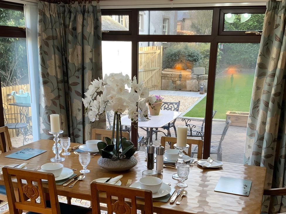 A dining room with a table set for meals at Fenton Drive Wooler