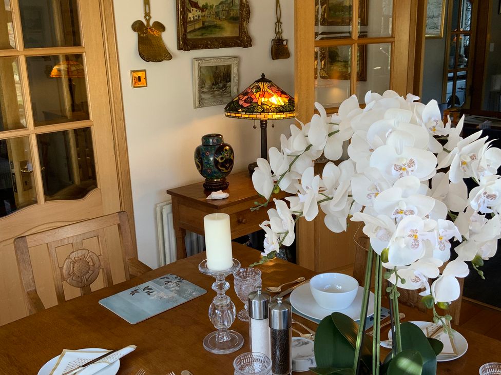 A dining room with a table set and decorative objects at Fenton Drive in Wooler