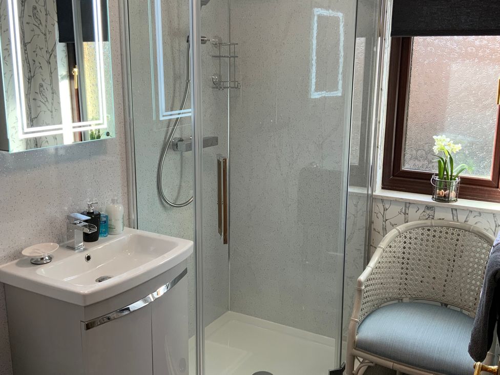 A bathroom with a shower and sink at Fenton Drive in Wooler