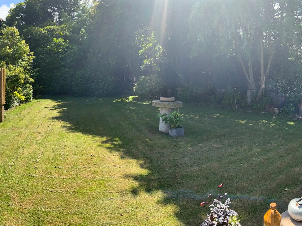 A garden with grass and a birdbath at Fenton Drive in Wooler