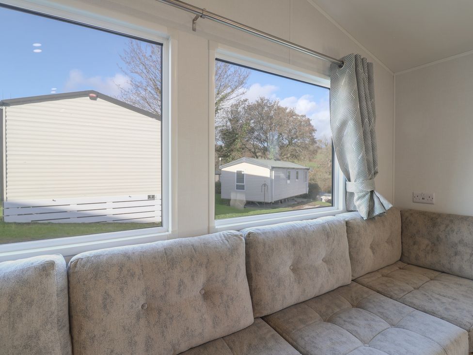 A living room with a sofa and windows at WF32 - Jurassic Discovery Charmouth