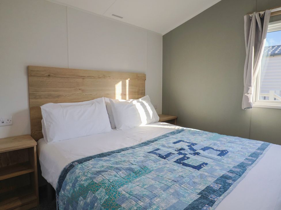A bedroom with a bed and bedside table at WF32 - Jurassic Discovery Charmouth