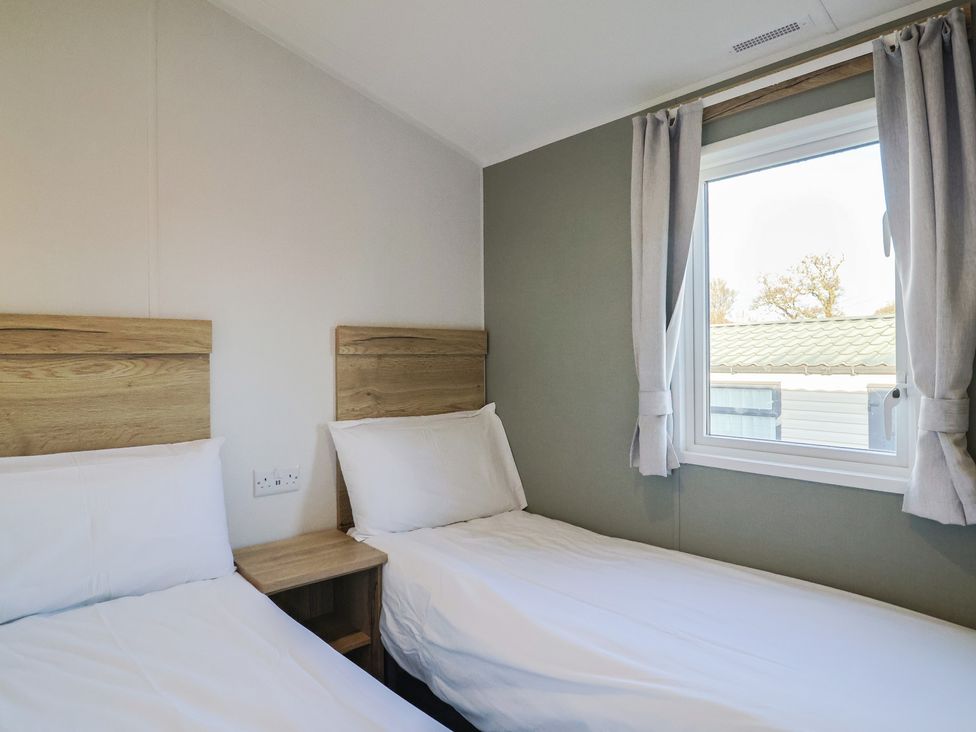 A bedroom with two beds and a window at WF32 - Jurassic Discovery, Charmouth