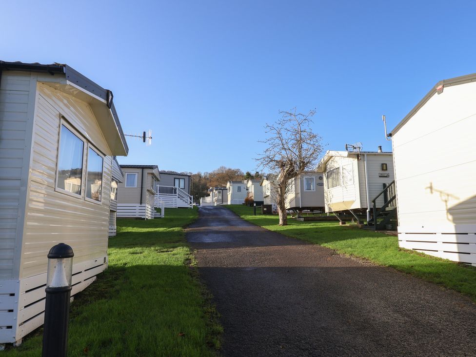 Mobile homes along a pathway at Jurassic Discovery in Charmouth