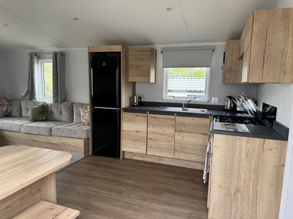 A kitchen with a sofa and dining table at Jurassic Discovery in Charmouth