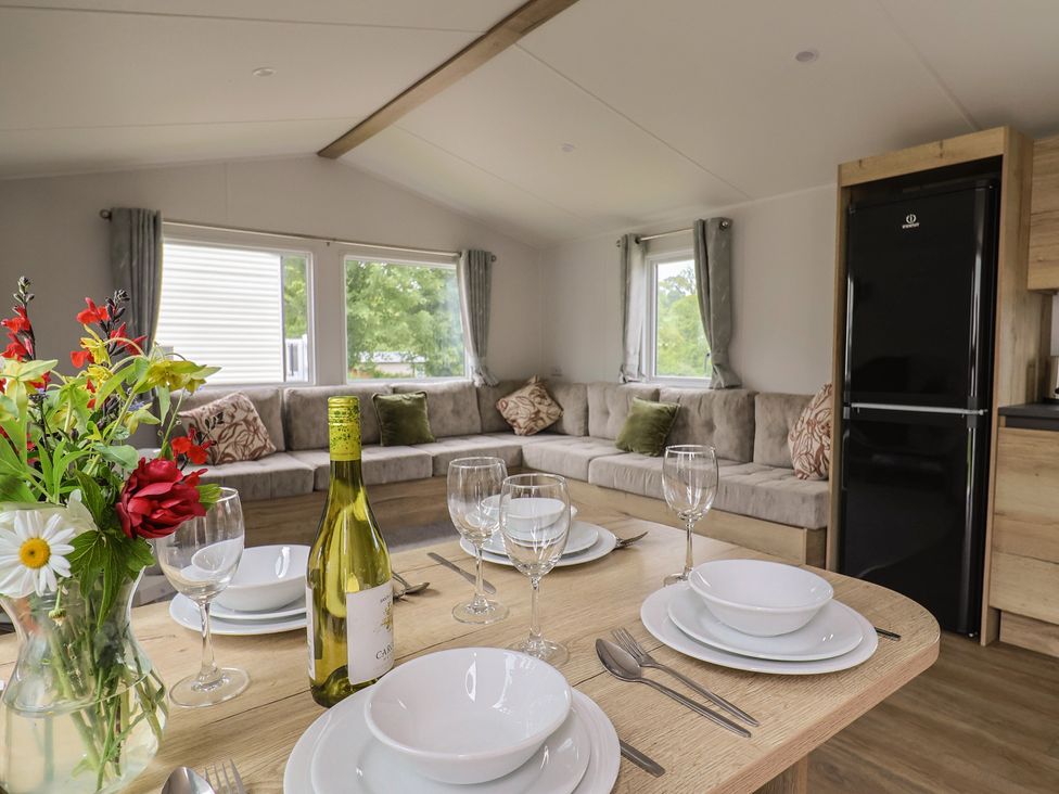 A living room with a sofa and dining table at Jurassic Discovery in Charmouth