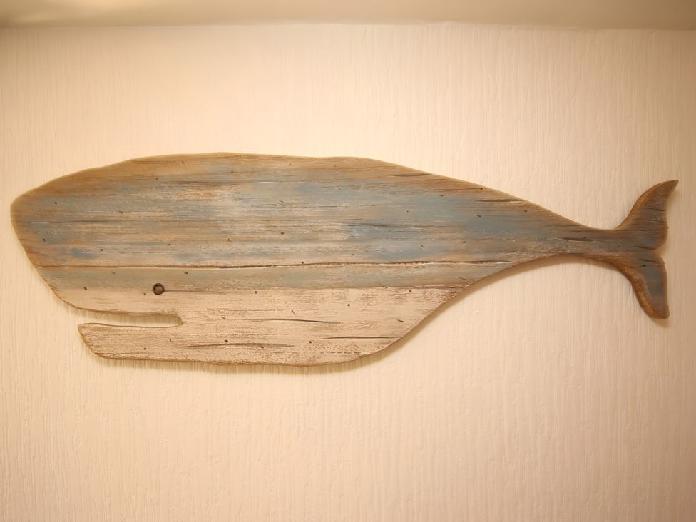 Wooden whale wall art at Zen Cottage in Buckie