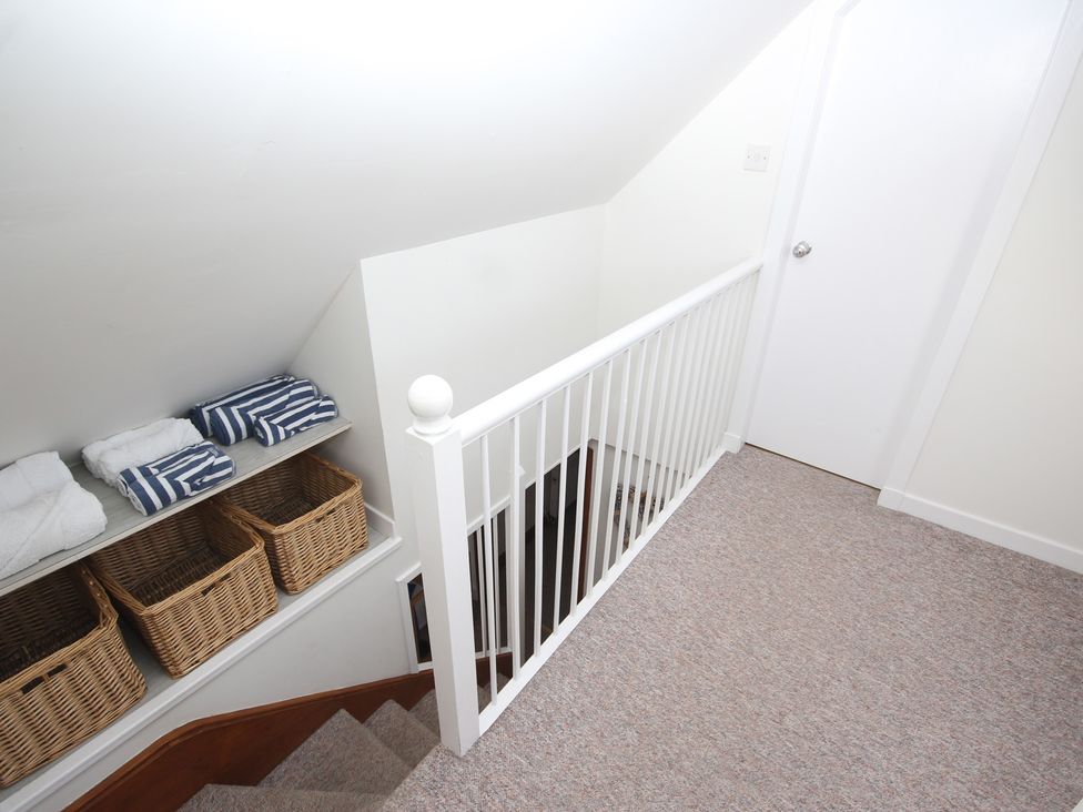 A stairwell with towels and baskets at Zen Cottage in Buckie