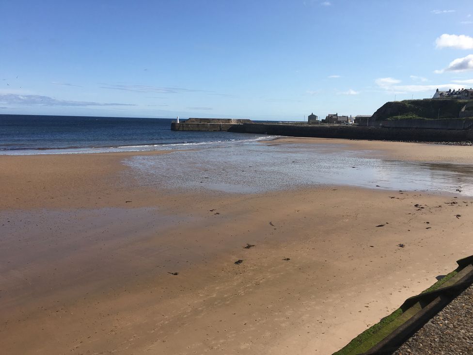 A beach view with water and sand at Zen Cottage in Buckie