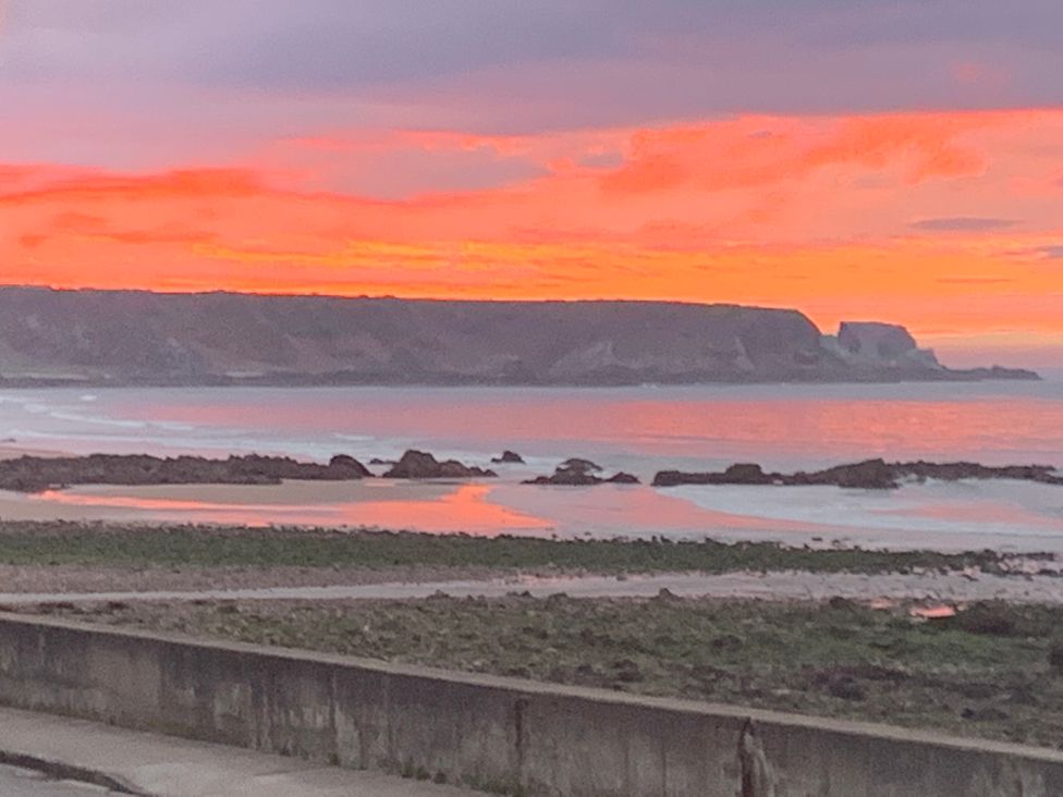 A beach during sunset at Zen Cottage in Buckie