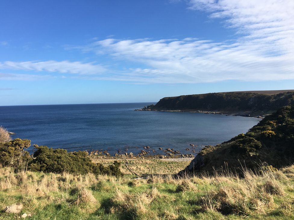 A coastal view of the sea and shore at Zen Cottage in Buckie