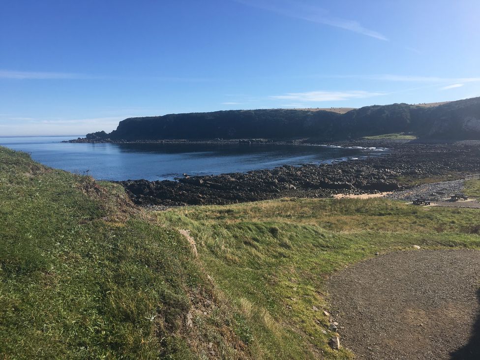 A coastline with rocks and water at Zen Cottage in Buckie
