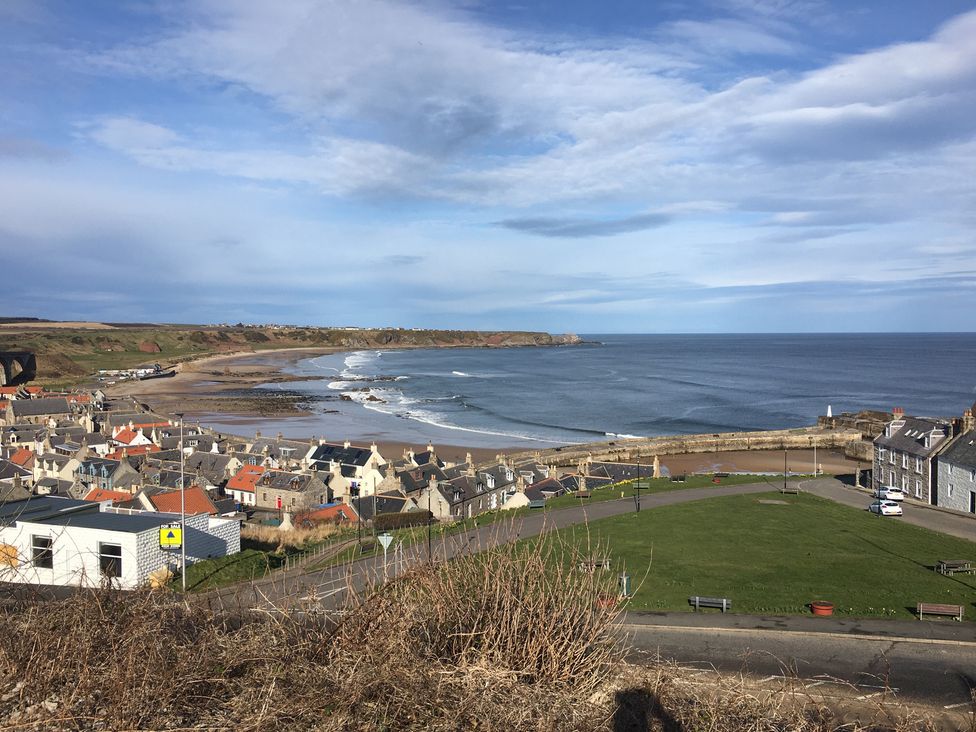 A coastal view with beach and houses at Zen Cottage in Buckie