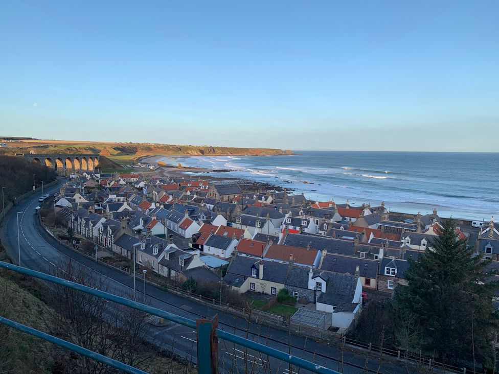 A view of houses and the ocean at Zen Cottage in Buckie