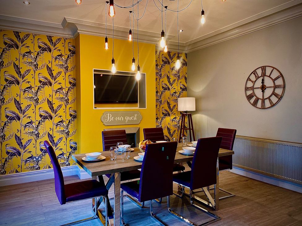 A dining room with a table and chairs at 1 Horncliffe Road in Blackpool