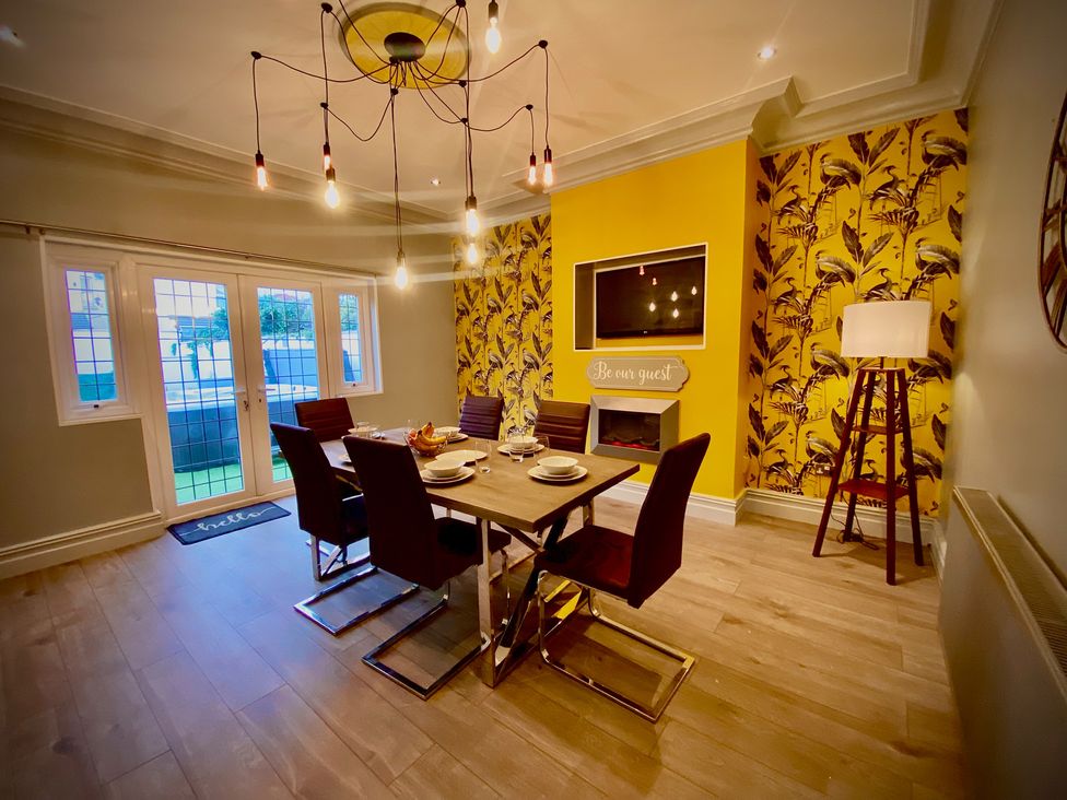 A dining room with a table and chairs at 1 Horncliffe Road in Blackpool