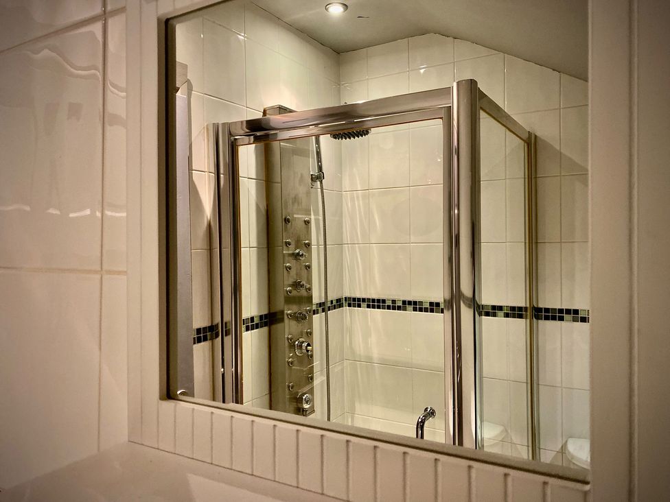 A shower enclosure with controls and tile wall at 1 Horncliffe Road in Blackpool