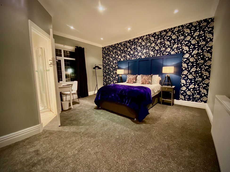 A bedroom with a bed and desk at 1 Horncliffe Road in Blackpool