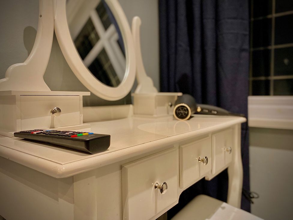 A vanity table with a mirror in a bedroom at 1 Horncliffe Road in Blackpool