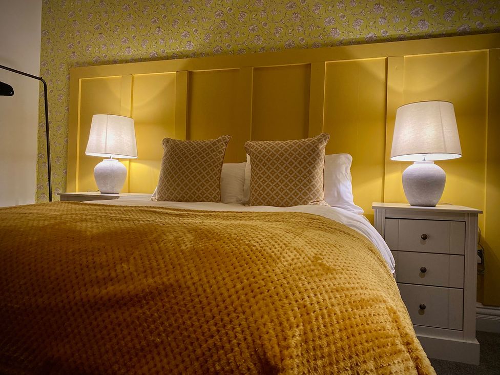 A bedroom with a bed and lamps at 1 Horncliffe Road in Blackpool