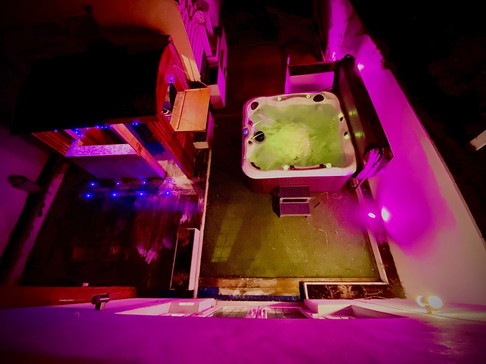 An outdoor area with a hot tub and a wooden shed at 1 Horncliffe Road Blackpool