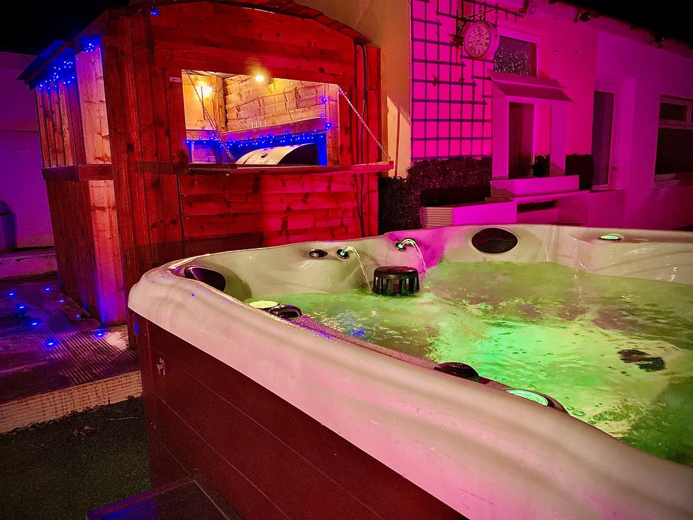 A hot tub and wooden shed with lights at 1 Horncliffe Road Blackpool