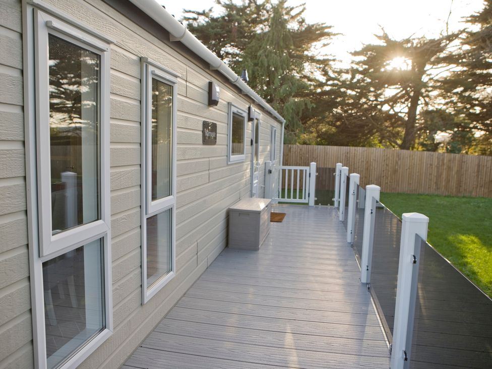 A deck area with windows and storage box at Orchid 9 Christchurch