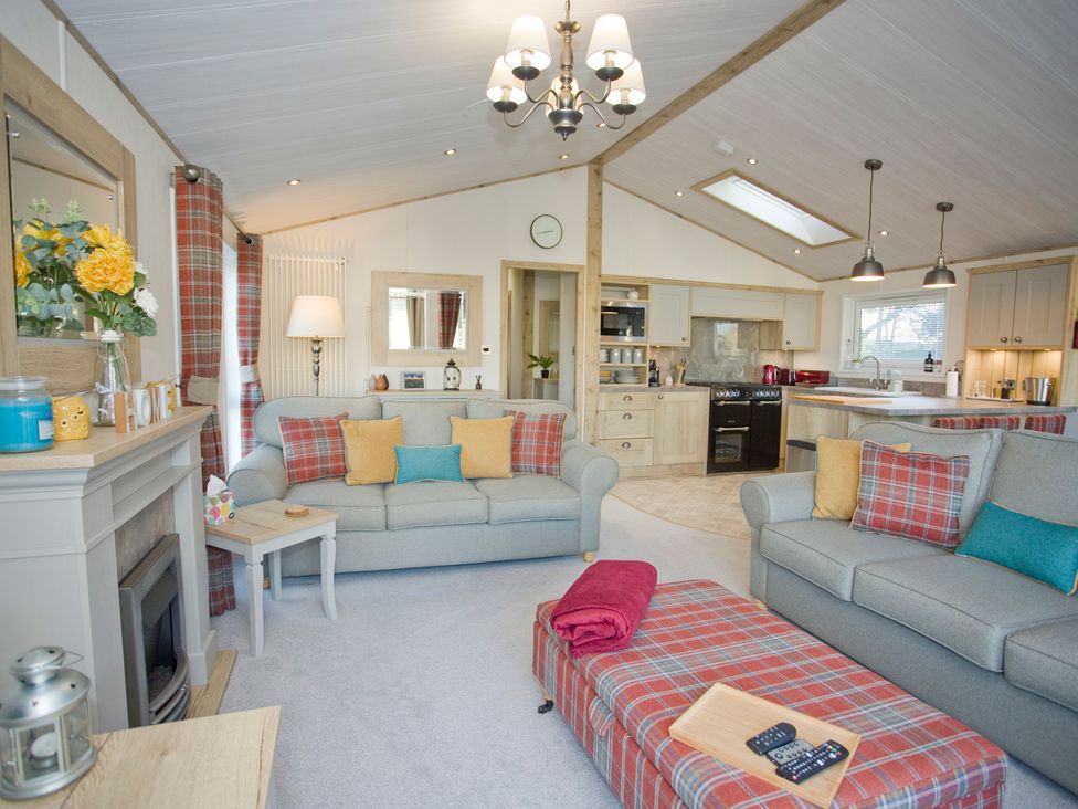 A living room with sofas and a coffee table at Orchid 9 Christchurch