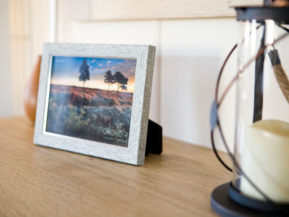 A photo frame on a table at Orchid 9 Luxury Lodge Christchurch
