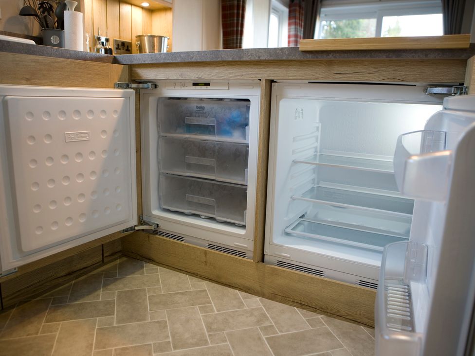 A kitchen with a refrigerator and freezer at Orchid 9 Christchurch