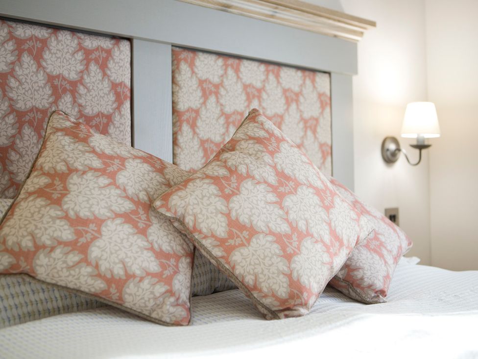 A bedroom with pillows on a bed at Orchid 9 Christchurch