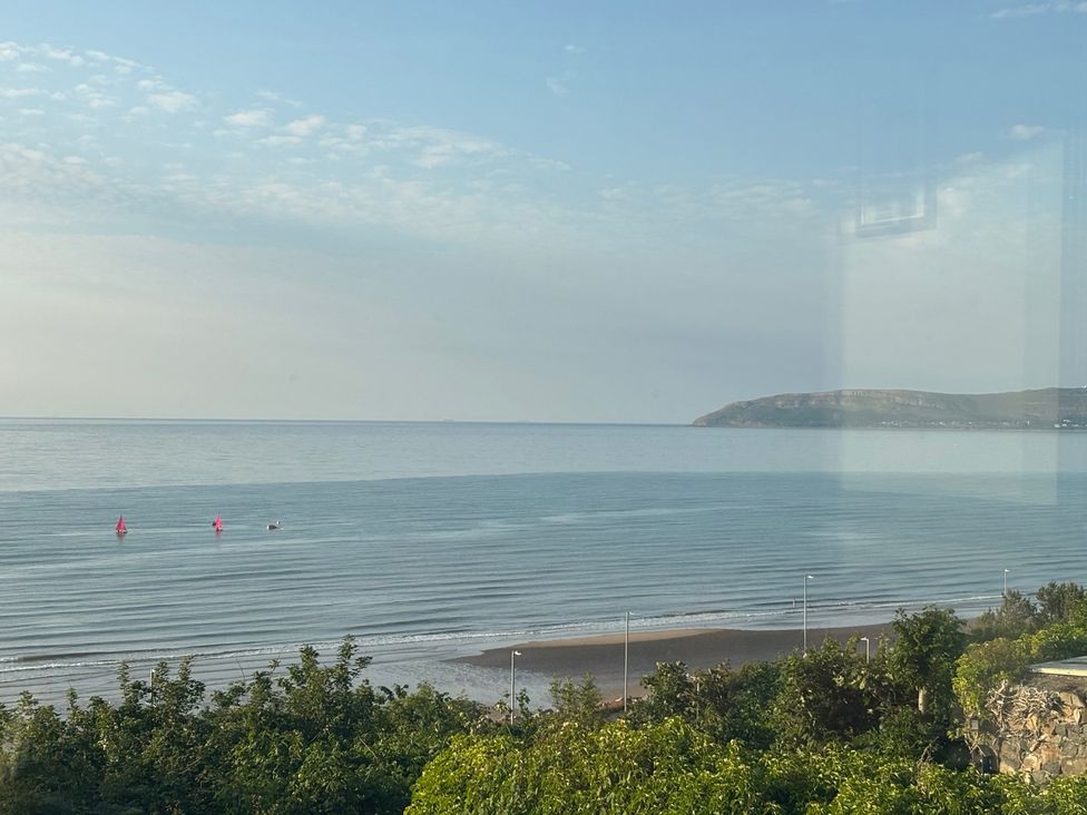 A view of the sea with boats at Penmaenmawr Coastal Retreat